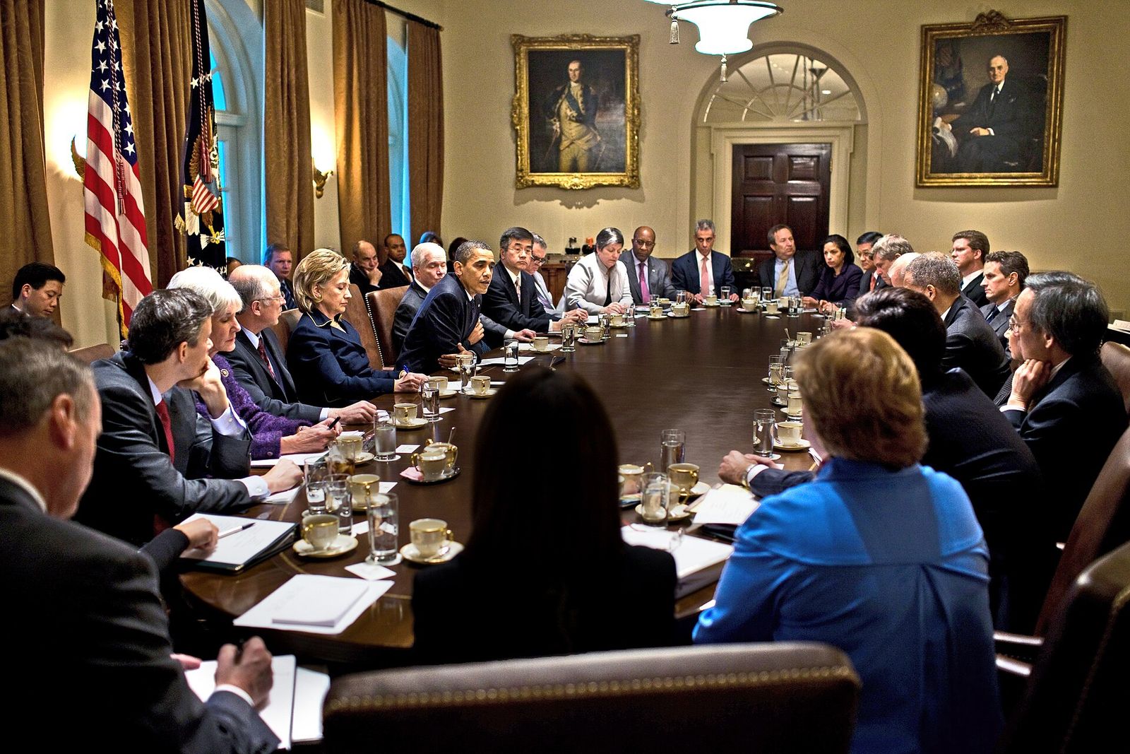 President Obama and members of his Cabinet seated around the long table in the Cabinet Room of the White House.