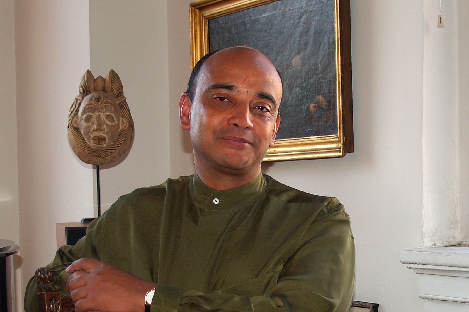 Philosopher Kwame Anthony Appiah seated with folded arms beside a chess table.