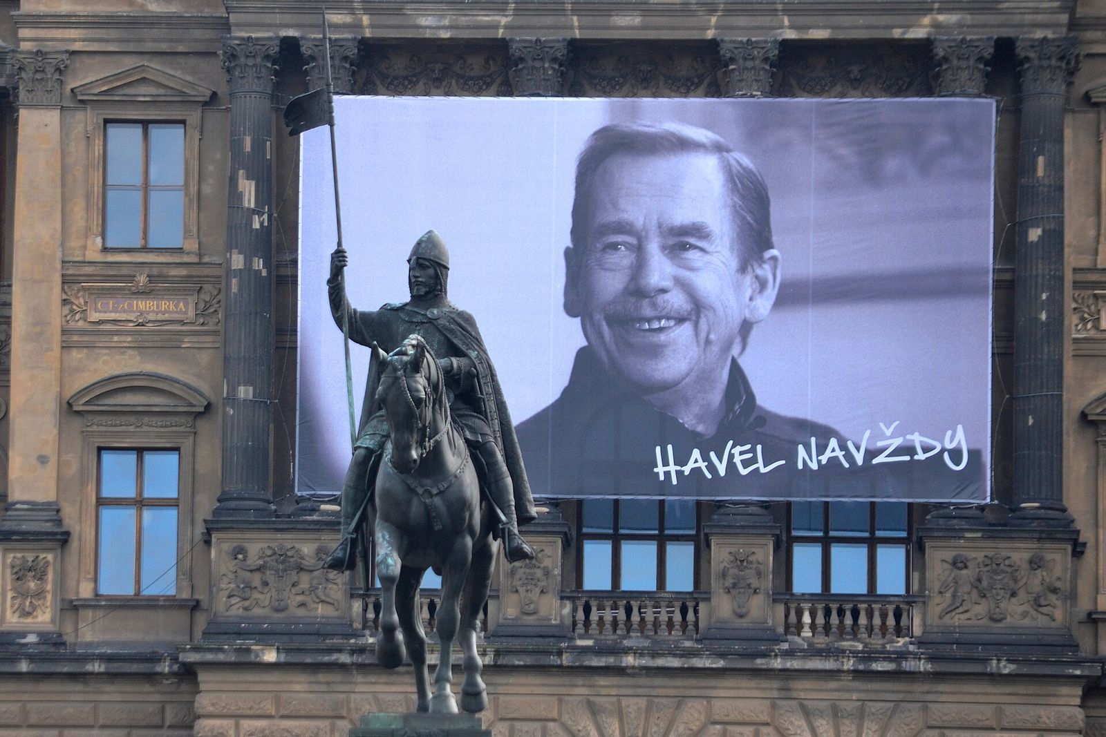 A giant black-and-white portrait of a smiling Václav Havel hung on the National Museum above the statue of St. Wenceslas.