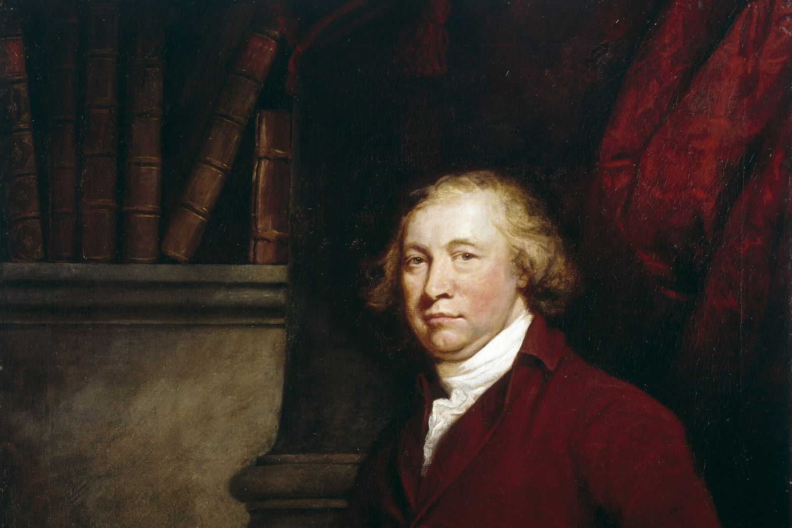 Portrait of Edmund Burke in a red coat, leaning on a desk with books and a quill behind him.